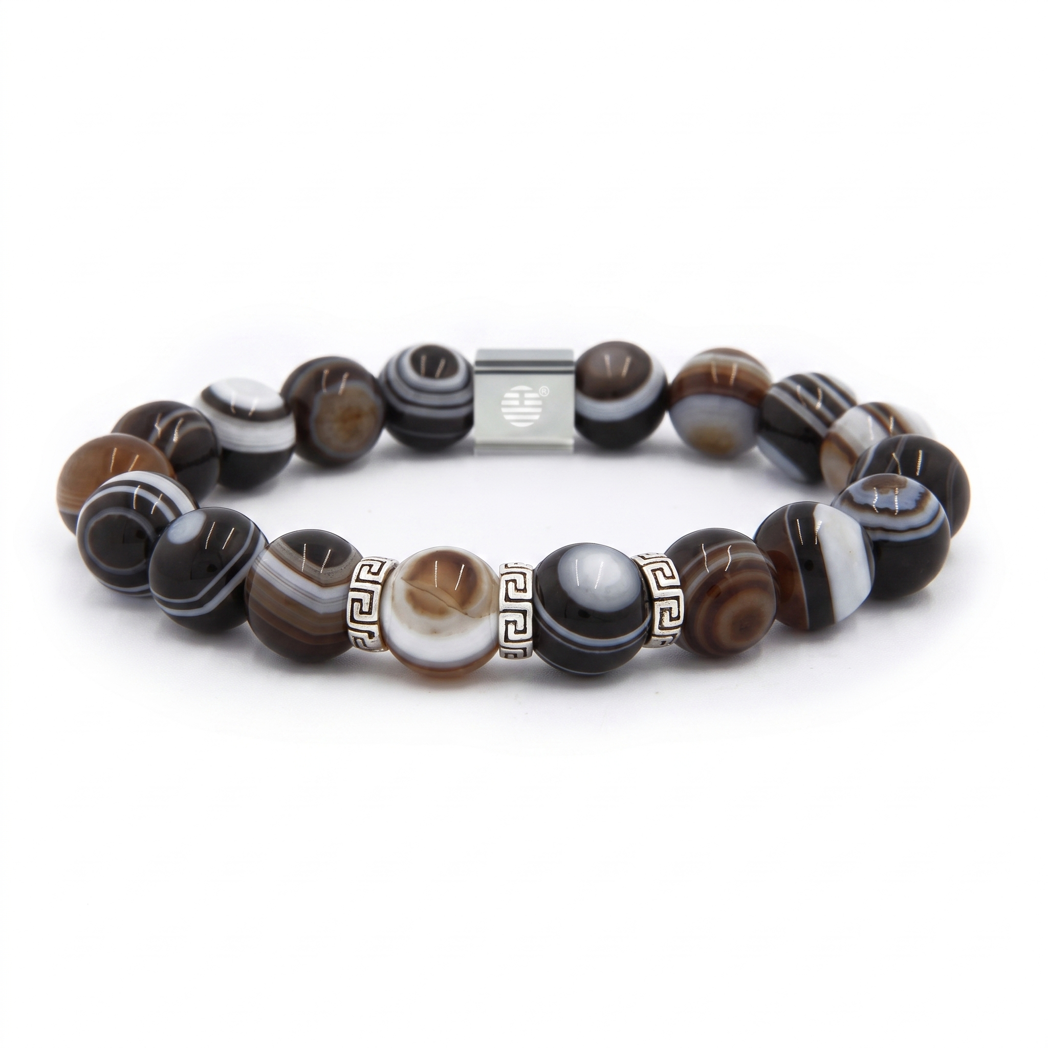 A beaded stretch bracelet featuring polished round beads with natural agate-like banding in black, white, brown, and gray, accented by a central silver-toned square bead and Greek key pattern spacers.