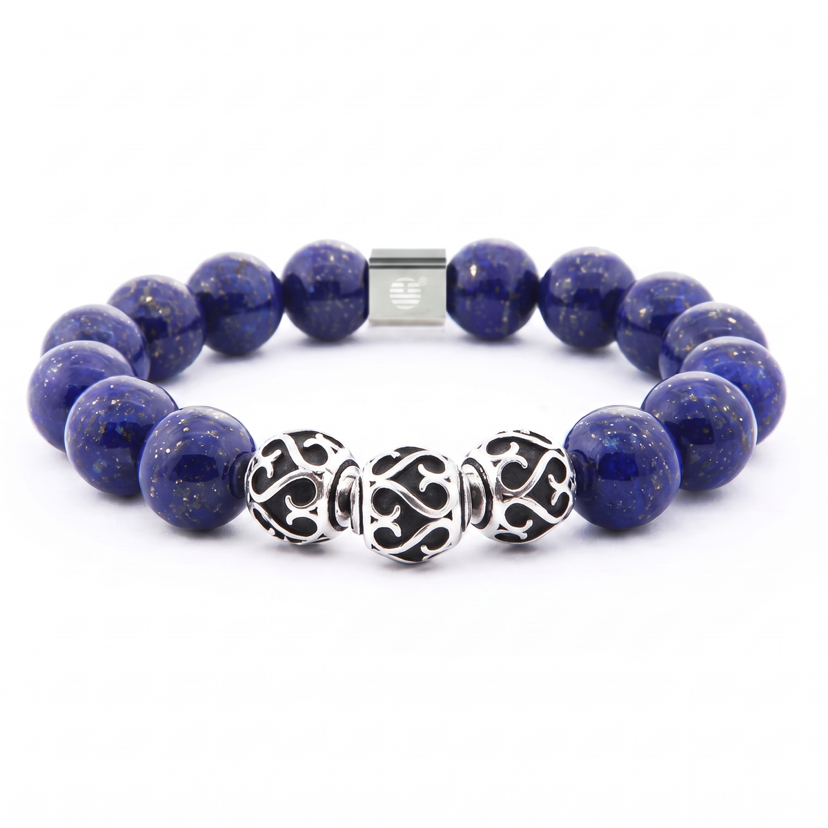 A beaded stretch bracelet featuring deep blue lapis lazuli stones with tiny gold flecks, accented by three ornate silver filigree beads and a silver magnetic clasp, shown on a white background.