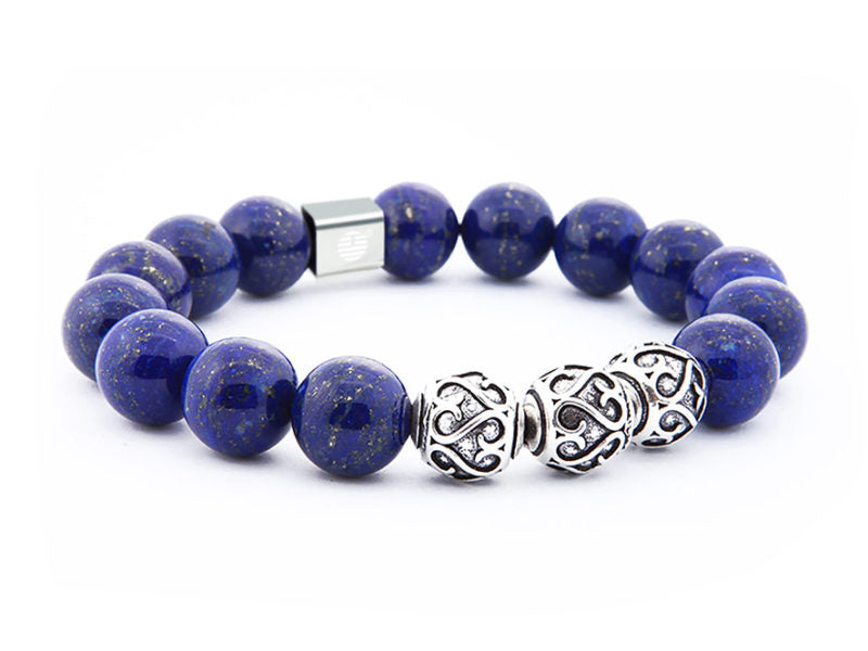 Blue beaded bracelet with a silver clasp on a white background