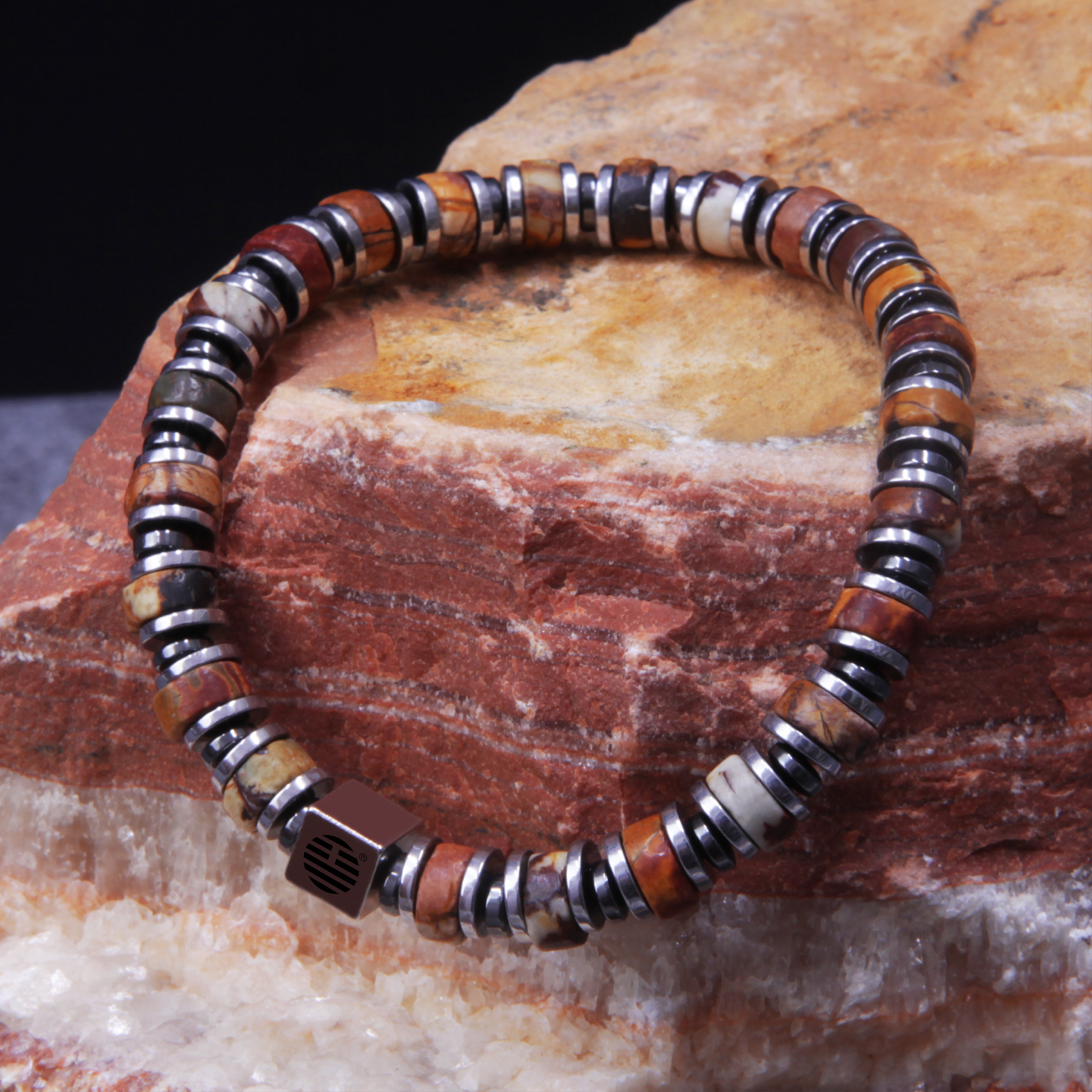 Multicolored beaded bracelet on a textured stone surface