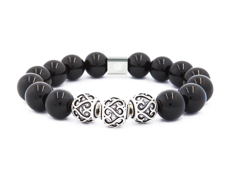 Black beaded bracelet with silver clasp and decorative beads on a white background