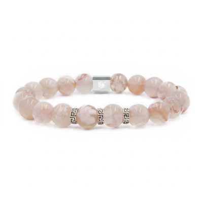 A beaded stretch bracelet made of pale pink and white marbled round beads, accented with silver-tone Greek key spacer beads and a silver magnetic clasp, shown on a plain white background.
