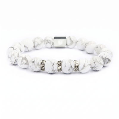 A beaded stretch bracelet made of white and gray marbled beads, featuring two gold Greek key pattern spacer beads and a silver magnetic clasp, shown on a plain white background.