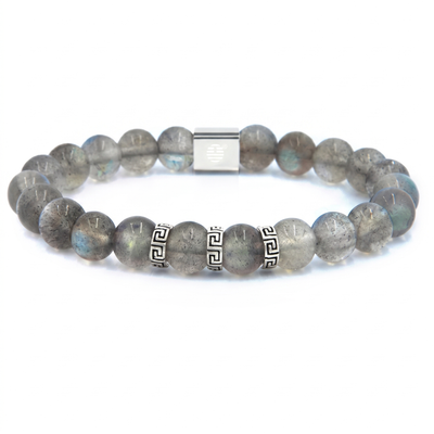 A beaded stretch bracelet made of gray labradorite beads with blue flashes, featuring two silver Greek key spacer beads and a silver magnetic clasp, shown on a white background.
