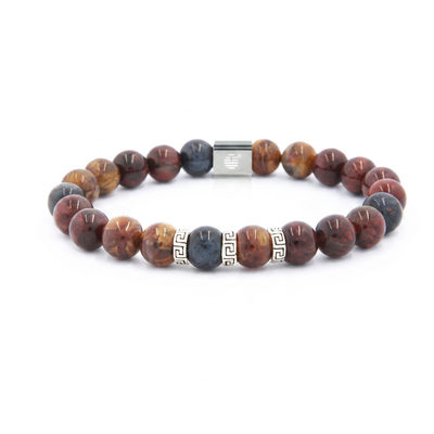 A beaded stretch bracelet featuring polished round stone beads in earthy brown, red, and black marbled patterns, accented by a dark blue-gray bead, a silver Greek key bead, and a silver magnetic clasp, shown on a plain white background.