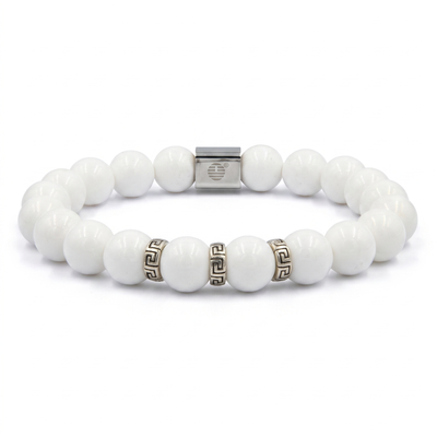 A white beaded stretch bracelet with a silver-toned square clasp and two small Greek key pattern spacer beads, shown on a plain white background.