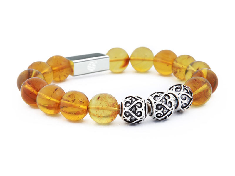 Bracelet with amber beads and a silver clasp on a white background