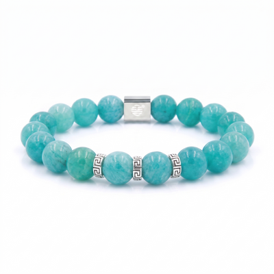 A beaded bracelet made of round turquoise-blue gemstone beads with silver-tone metal accents, including a central clasp and small Greek key spacer beads, shown on a plain white background.