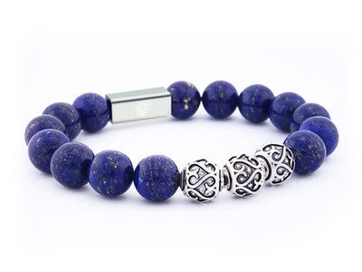 Blue beaded bracelet with a silver clasp and Celtic knot charm on a white background