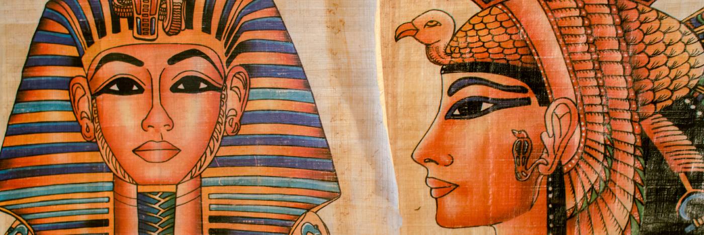 Close-up of an ancient Egyptian-style artwork showing part of a pharaoh's face with a striped headdress on the left and a profile portrait with a bird headdress on the right, rendered in warm tan, orange, black, and blue tones on aged paper.